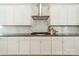 Bright kitchen features white cabinets, stainless steel hood, modern backsplash, and sleek countertops at 11036 Shreveport Dr, Huntersville, NC 28078