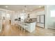 Another view of the kitchen with white cabinets, counter seating, and modern appliances at 11036 Shreveport Dr, Huntersville, NC 28078