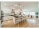 Spacious kitchen with white cabinetry, a large island, and an open floor plan at 11036 Shreveport Dr, Huntersville, NC 28078