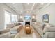 Cozy living room features fireplace, coffered ceiling, large windows, and stylish furnishings at 11036 Shreveport Dr, Huntersville, NC 28078