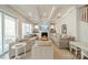 Spacious living room with coffered ceiling, fireplace, large windows, and comfortable seating arrangement at 11036 Shreveport Dr, Huntersville, NC 28078