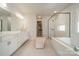 Bright main bathroom with double vanity, shower, tub, and ample space at 11036 Shreveport Dr, Huntersville, NC 28078