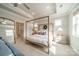 Bright main bedroom with a four poster bed, plenty of natural light, and neutral tones at 11036 Shreveport Dr, Huntersville, NC 28078