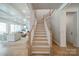 Bright staircase with hardwood floors, leading to the upper level at 11036 Shreveport Dr, Huntersville, NC 28078