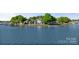 An aerial shot of an elegant waterfront estate on a lush peninsula with a private dock at 114 Ventana Ct, Mooresville, NC 28117