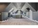 This expansive bonus room features a TV, skylights, and ample seating at 114 Ventana Ct, Mooresville, NC 28117