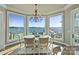 A cozy breakfast nook with panoramic windows offering stunning waterfront views at 114 Ventana Ct, Mooresville, NC 28117