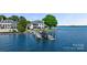 A picturesque waterfront property features a dock, boats, and inviting outdoor spaces at 114 Ventana Ct, Mooresville, NC 28117