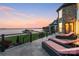 Relaxing outdoor patio featuring waterfront views, chaise lounges, and black metal railings at 114 Ventana Ct, Mooresville, NC 28117