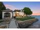 A beautiful waterfront home features a manicured lawn and stunning lake views at 114 Ventana Ct, Mooresville, NC 28117