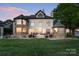A sprawling house is surrounded by a well-manicured lawn and beautiful landscaping at 114 Ventana Ct, Mooresville, NC 28117