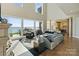 Bright living room with hardwood floors, large windows overlooking the lake, and neutral tones at 114 Ventana Ct, Mooresville, NC 28117