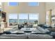 A spacious living room with high ceilings and large windows that overlook the lake at 114 Ventana Ct, Mooresville, NC 28117
