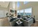 An open-concept living room featuring a fireplace, hardwood floors, and lake views at 114 Ventana Ct, Mooresville, NC 28117