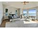 A luxurious main bedroom with sitting area, ensuite bathroom, and waterfront views at 114 Ventana Ct, Mooresville, NC 28117