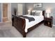 Cozy bedroom featuring soft carpet, neutral décor and en suite bath access at 11901 Rock Canyon Dr, Charlotte, NC 28226