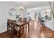 Bright dining room with wooden table and chairs, with an open view of other rooms at 11901 Rock Canyon Dr, Charlotte, NC 28226