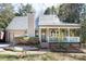 Charming home featuring a cozy front porch and well-maintained landscaping at 11901 Rock Canyon Dr, Charlotte, NC 28226