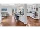 Bright kitchen featuring granite countertops, white cabinetry and hardwood floors at 11901 Rock Canyon Dr, Charlotte, NC 28226