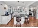 Well-lit kitchen with a large island, white cabinets, and stainless-steel appliances at 11901 Rock Canyon Dr, Charlotte, NC 28226
