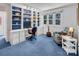 Office with custom shelving, window, and comfortable seating at 11901 Rock Canyon Dr, Charlotte, NC 28226