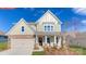 Charming two-story home with stone accents, a covered porch, and an attached two-car garage at 128 Fordingbridge Ln, Mooresville, NC 28115