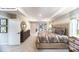 Spacious primary bedroom featuring tray ceilings, dresser, and ensuite bathroom at 128 Fordingbridge Ln, Mooresville, NC 28115