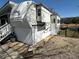 Exterior view of a well-maintained mobile home with white siding and landscaped surroundings at 134 Putt Putt Ln, New London, NC 28127