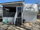 Exterior view of the home featuring a screened porch and a convenient staircase leading to the entrance at 134 Putt Putt Ln, New London, NC 28127
