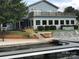 Charming two-story building with a balcony overlooking the marina and waterfront with well-maintained landscaping at 134 Putt Putt Ln, New London, NC 28127