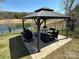 Outdoor gazebo featuring a cozy seating arrangement and a lakeside view, perfect for outdoor gatherings at 134 Putt Putt Ln, New London, NC 28127