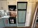 The kitchen features vintage cabinets, a black microwave, modern appliances, stainless steel sink, and good natural light at 134 Putt Putt Ln, New London, NC 28127