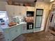 A cozy kitchen with vintage cabinets, a black microwave, modern appliances, ample counter space, and good natural light at 134 Putt Putt Ln, New London, NC 28127