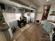 Living area featuring wood floors, neutral walls, and vintage cabinets in a room with natural light and stylish decor at 134 Putt Putt Ln, New London, NC 28127