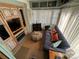 The living room offers natural light, modern sofa, vintage cabinets, wood floors, and is decorated with charming pillows at 134 Putt Putt Ln, New London, NC 28127