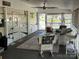 Spacious screened-in porch with seating area, ideal for relaxing and entertaining with the comforts of home at 134 Putt Putt Ln, New London, NC 28127