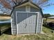 Well-maintained shed with double doors near the lake, providing ample storage with outdoor access for your convenience at 134 Putt Putt Ln, New London, NC 28127