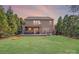Spacious backyard with a well-maintained lawn, a cozy patio area, and lush landscaping for outdoor relaxation at 1504 Ridge Haven Rd, Waxhaw, NC 28173