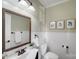 Charming bathroom features beadboard walls, framed mirror, and classic fixtures at 1504 Ridge Haven Rd, Waxhaw, NC 28173