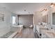 Stylish bathroom with double vanities, a standalone tub, and a glass enclosed shower at 1504 Ridge Haven Rd, Waxhaw, NC 28173
