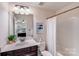 This bathroom includes a shower and bathtub with shower curtain and a single sink vanity at 1504 Ridge Haven Rd, Waxhaw, NC 28173