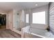 Contemporary bathroom featuring a glass shower, soaking tub, and stylish fixtures at 1504 Ridge Haven Rd, Waxhaw, NC 28173