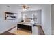 This bedroom features an art piece, ceiling fan, two windows, and hardwood floors at 1504 Ridge Haven Rd, Waxhaw, NC 28173