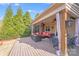 Relaxing covered deck with outdoor seating, dining area, and wooded views at 1504 Ridge Haven Rd, Waxhaw, NC 28173