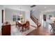 Bright dining area featuring wood floors, a pendant light, and direct staircase access at 1504 Ridge Haven Rd, Waxhaw, NC 28173