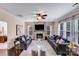 Comfortable living room featuring a stone fireplace and abundant natural light at 1504 Ridge Haven Rd, Waxhaw, NC 28173