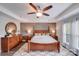 Stately main bedroom with wood accent wall, a ceiling fan, dresser and natural light at 1504 Ridge Haven Rd, Waxhaw, NC 28173