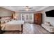 Light-filled bedroom with tray ceiling, wood accent wall, and a window view at 1504 Ridge Haven Rd, Waxhaw, NC 28173
