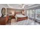 Spacious main bedroom with a luxurious bed, tray ceilings, and wood accent wall at 1504 Ridge Haven Rd, Waxhaw, NC 28173