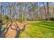 Expansive backyard featuring mature trees and green grass offers a private and serene outdoor space at 1537 Wheaton Nw Way, Concord, NC 28027